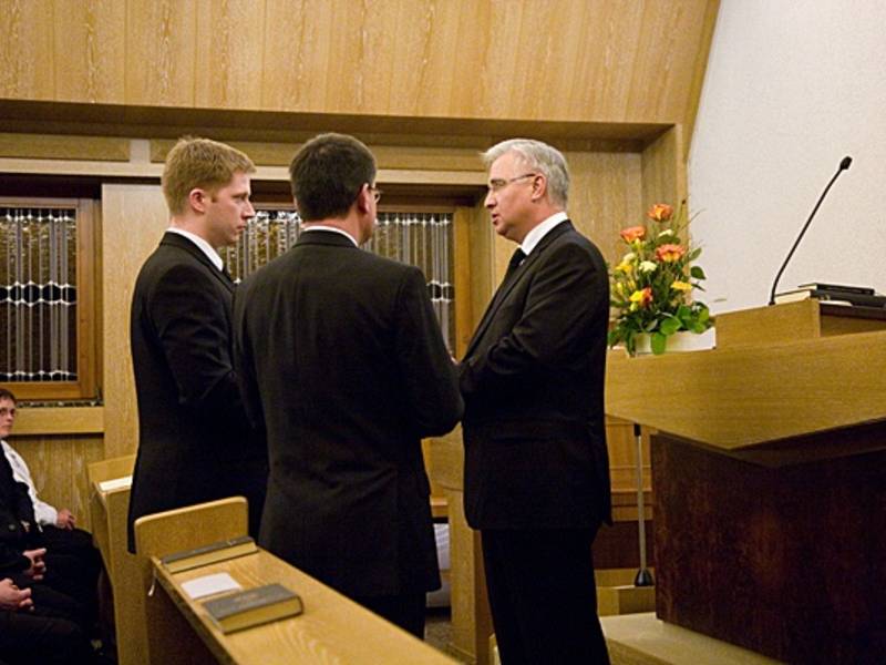 Bezirksapostel Nadolny ordiniert einen Gemeindeevangelisten und einen Priester.